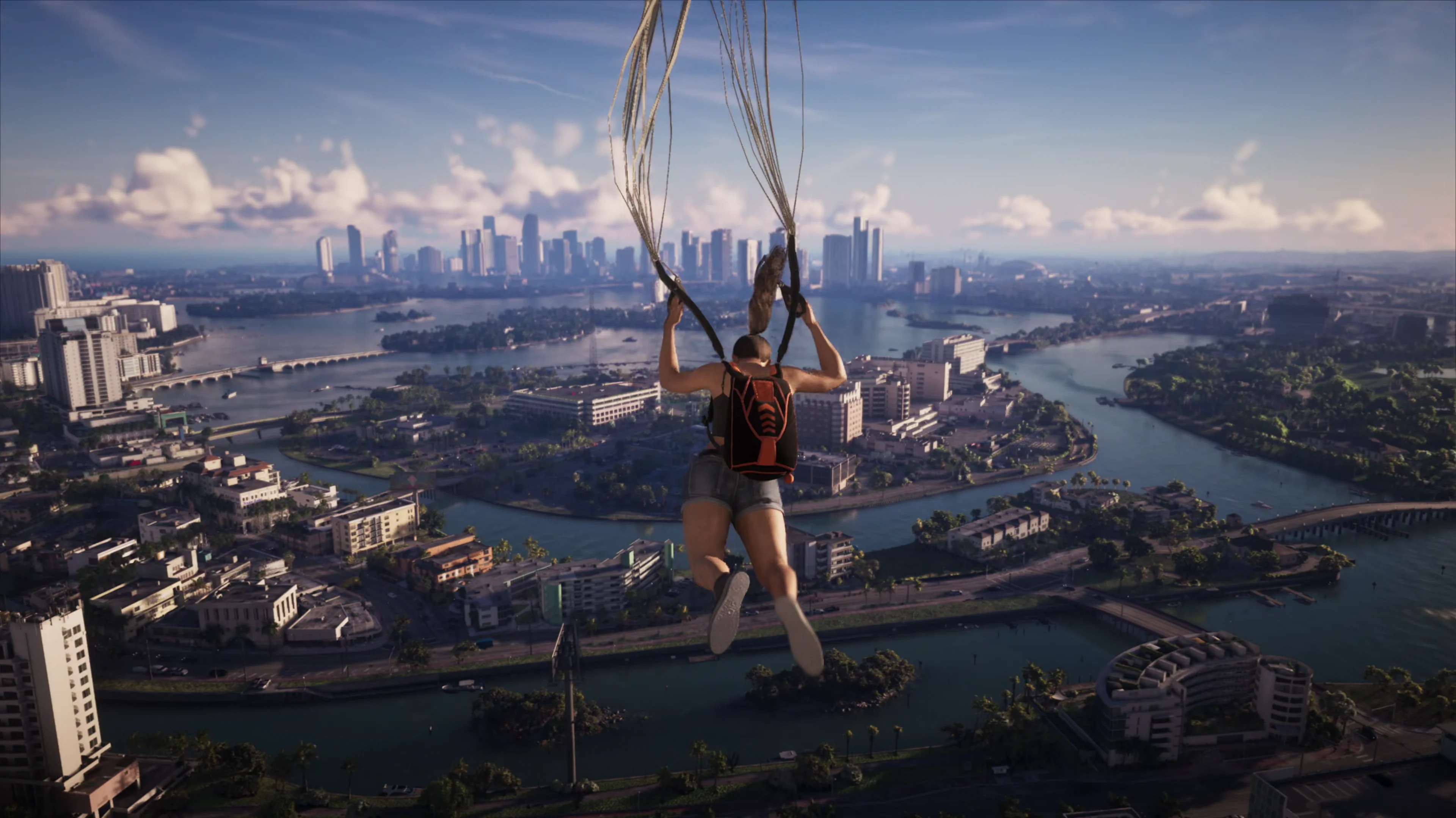 A parachute descent over Vice City, the canals, low blocks and marinas laid out below and the downtown skyline across the water
